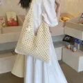 Handmade crochet hollow-out beach tote bag in beige displayed on shoulder - Off White