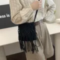 Handwoven black macrame phone shoulder bag featuring long tassels and braided strap - Black