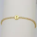Detailed view of gold tennis bracelet featuring letter B charm and shimmering cubic zirconia. - Letter B (DB260303-B)