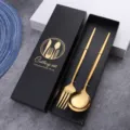 Gold stainless steel cutlery set featuring a fork and spoon in a luxury black gift box. - Titanium Gold Spoon & Fork Set - Color Box
