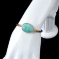 Adjustable woven cord gemstone bracelet featuring a faceted oval stone in a chic gold bezel setting. - Amazonite