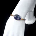 Natural faceted stone beaded bracelet with gold bezel and adjustable brown cord style variant - Blue Sodalite