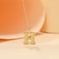 Gold-plated letter H pendant necklace with delicate chain, elegant fashion jewelry item. - Letter H