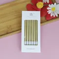 Set mit 6 langen goldenen Bleistift-Geburtstagskerzen in weißer Verpackung für Torten - 6-teiliges Set / Gold