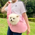 Vista detallada de bolsa bandolera rosa para mascotas con perro, tejido suave y transpirable. - M (Hasta 7,5 kg) / Rosa