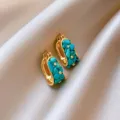 Close-up detail shot of vintage gold hoop earrings showcasing turquoise stones and zirconia. - 3# Real Gold-Plated Huggie Earrings - Gold & White