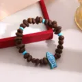 Unique coffee bean charm bracelet with blue fish pendant and turquoise beads detail - Coffee