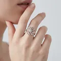 Minimalist silver-tone open ring with intricate hollow floral texture shown on index finger - Hollow Petal Open Ring / Steel