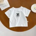 Detail view of infant white cotton short sleeve t-shirt with cute chest print and size tag. - 66cm / Short Sleeve T-Shirt