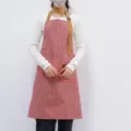 Red and white striped kitchen apron with adjustable brown straps for cooking variant. - Red