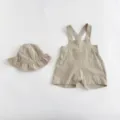 Detailed shot of the baby cotton linen solid strap romper and matching sun hat set style. - 100cm / Set / Apricot