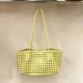 Yellow woven leather tote bag detailed view, elegant cutout geometric shoulder handbag. - Bright yellow