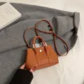 Chic brown leather mini handbag with top handles and shoulder strap for women daily commute style. - S / Brown