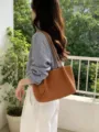 Korean style woven tote bag for women, chic brown leather shoulder bag detail view. - Orange