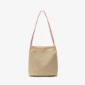 Woven straw bucket bag detail view, natural texture, elegant pink shoulder strap design. - Pink
