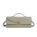 Detailed shot of trendy green woven leather shoulder baguette bag with chic metal knot handle. - Sage Green
