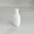 Close-up detail view of white plastic siphon accessory valve part with faceted design - White