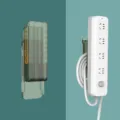 Wall-mounted punch-free socket holder and cable organizer for home power strip management. - Green