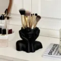 Creative human face art makeup brush holder desktop pen storage organizer for vanity decor. - Black Face-Covering Figure
