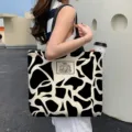 Large capacity canvas tote bag featuring a stylish black and white cow print pattern - Encounter Bears