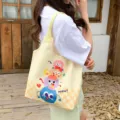 Canvas tote bag for women, cute cartoon monster print, large capacity casual shoulder bag. - Cute Monster Stack