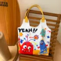 Cartoon monster print canvas tote bag with yellow straps, cute casual student shoulder bag. - Funny Monster Carnival