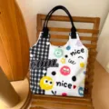 Cute cartoon monster canvas tote bag for women, stylish black and white checkered shoulder bag. - Energetic Soot Sprite
