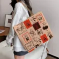 Large capacity beige canvas tote bag with cute animal cartoon prints for college students - Cat Grill Fish