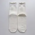 White women's mid-calf yoga socks with ruffles and non-slip grip soles for fitness pilates. - One Size / Creamy White