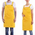 Yellow adjustable shoulder work apron detail view with chest pocket and durable fabric. - Yellow