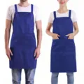 Detail view of the adjustable polyester work apron with useful pockets for staff and chefs. - Blue