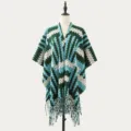Elegant green and blue knitted cape shawl with fringe hem, warm winter outerwear. - Geometric Peaks Blue Green
