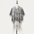 Women's black and white knit poncho shawl with abstract pattern and stylish fringe hem. - Ink Paisley Black and Beige