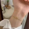 Dainty gold chain bracelet with a cute knot charm and sparkling crystal, elegant jewelry variant. - 3D Knot Rhinestone Pendant Style (MY36676)