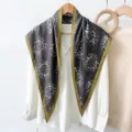 Detailed view of abstract printed triangle scarf with green border, versatile accessory. - RY-33