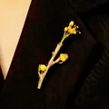 Creative silver branch brooch with yellow dried flowers on a black suit lapel. - Branch Flower Arrangement Brooch (WG-0895) / Gold