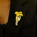Elegant gold flower bouquet brooch with yellow blossoms pinned on black suit lapel - Flower Arranging Brooch (3466) / KC Gold