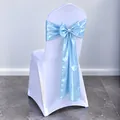 Elegant light blue satin bow sash tied on a white elastic wedding chair cover - Sky Blue