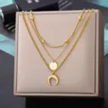 Detail view of a multi-layer gold-colored necklace with moon and star pendants for women. - Triple Layer Stacking Star Disc and Moon Style (N04307) / Gold