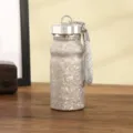 Portable mini thermos bottle detail view featuring silver glitter texture and braided lanyard. - Silver