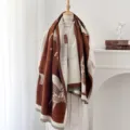 Detailed view of vintage horse pattern jacquard shawl with soft tassels on mannequin - Caramel color