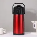 Detailed close-up view of the red stainless steel thermal air pot with pump dispenser. - 2.5L / Red