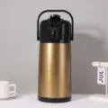 Detailed view of large thermal airpot with golden brushed finish and black top handle. - 2.5L / Gold