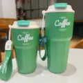 Stainless steel portable coffee travel mug with carrying strap leakproof thermal tumbler. - Green