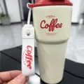 Portable stainless steel coffee tumbler with carrying strap and stylish red lid variant. - 620ml New Model White