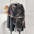 Close-up view of a vintage geometric pattern scarf with fringes draped elegantly over a grey coat. - Greek Key Pattern - Black / 200*65cm