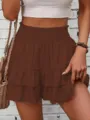 Close-up detail of the stylish brown tiered ruffle skirt-pants showing draped texture. - Coffee