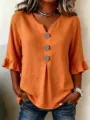 Detail view of the orange loose casual shirt featuring a V-neck, big buttons and ruffle sleeves. - 3XL / Orange