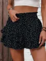 Close-up of black polka dot ruffled tiered shorts with smocked high waist design. - Black White Polka Dot Print