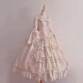 Detailed view of the exquisite pink Lolita princess dress featuring delicate lace and bows. - S / Pink